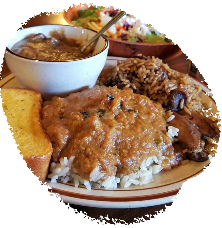 A plate of Cajun rice, gravy, toast, and salad