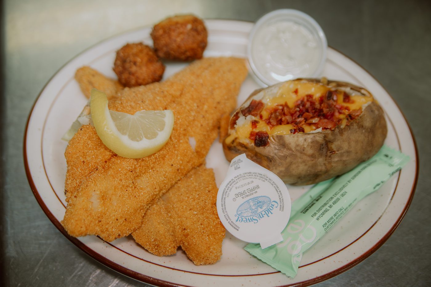 Fried fish platter with baked potato and hushpuppies